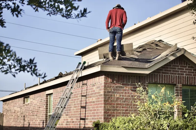 Professional roofer working on a residential roof in Goresville